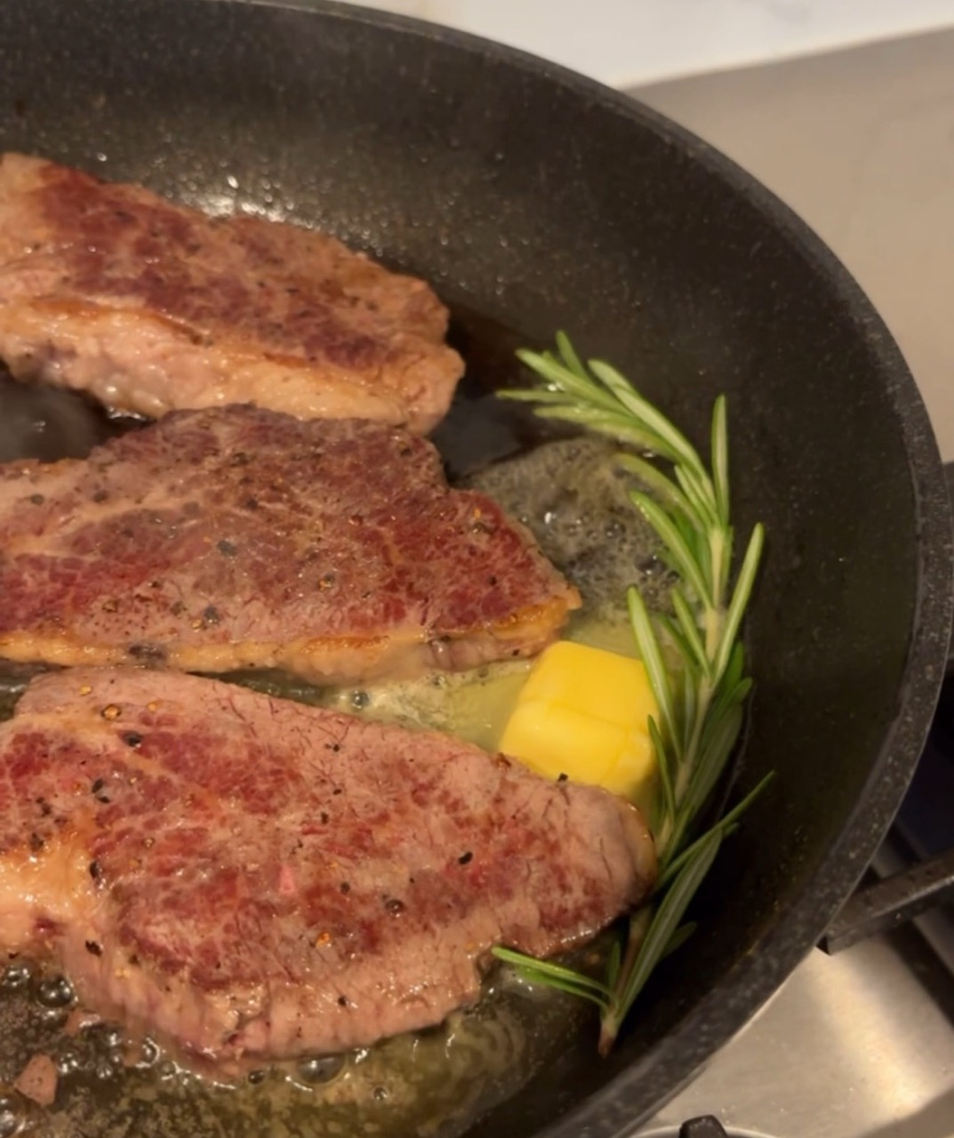 August cooking tri tips with butter and rosemary